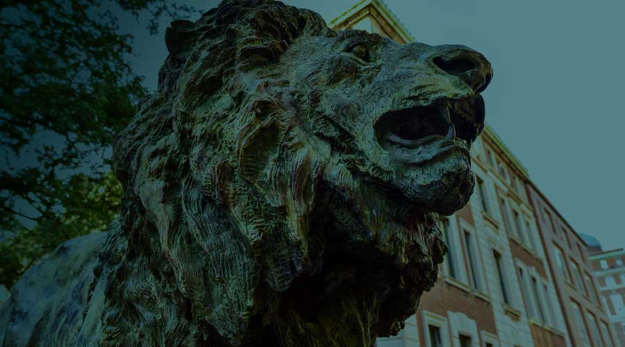 A statue of a lion outside a business building