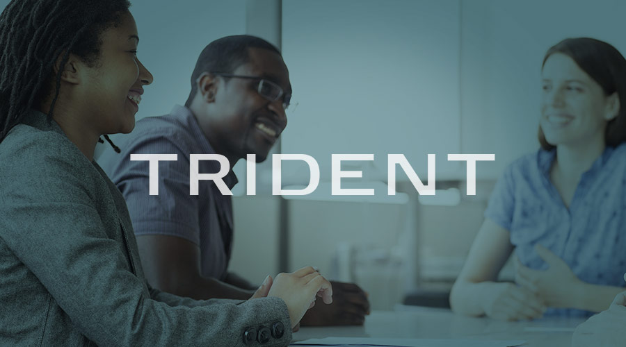 Meeting of diverse board room members with Trident logo
