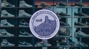 Pensole Lewis College emblem over wall of sneakers