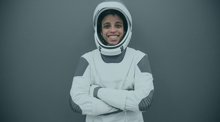 Astronaut Jessica Watkins smiles while wearing her SpaceX space suit