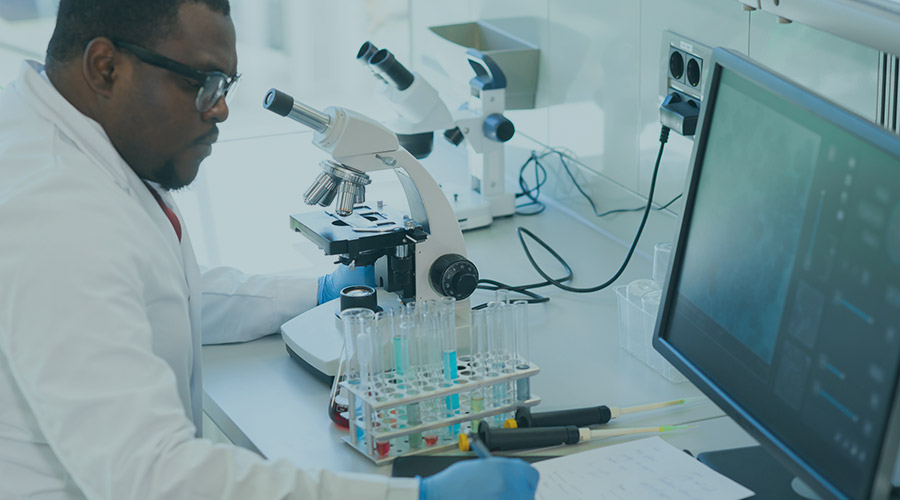 A black scientist using tools in the lab.