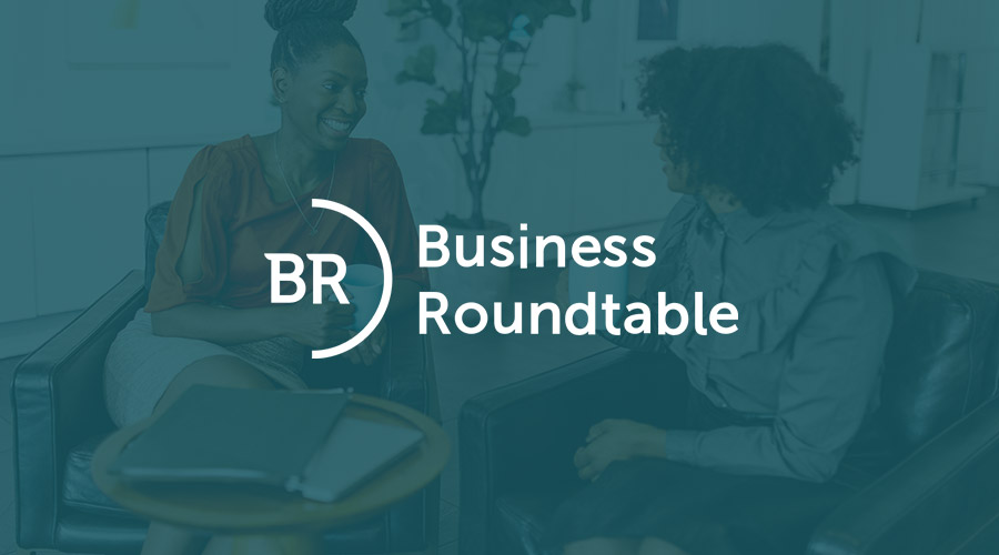 Graphic image of two women sitting in chairs with an overlay of the Business Roundtable logo