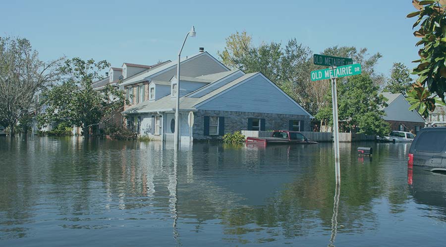 A photo of houses and cars under water after a hurricane.