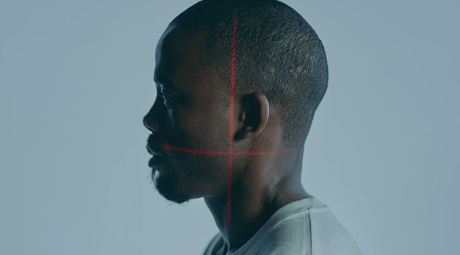 A side profile picture of a Black man's face.