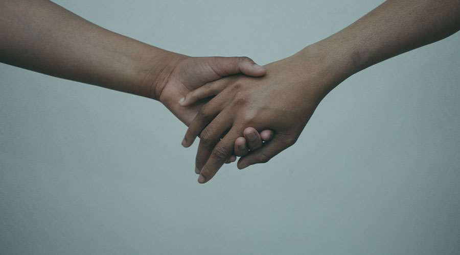 An up close photo of two hands being held together.