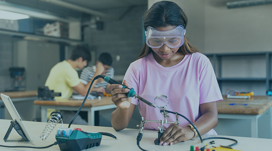 Image of a young African American girl working in a lab on a science project.