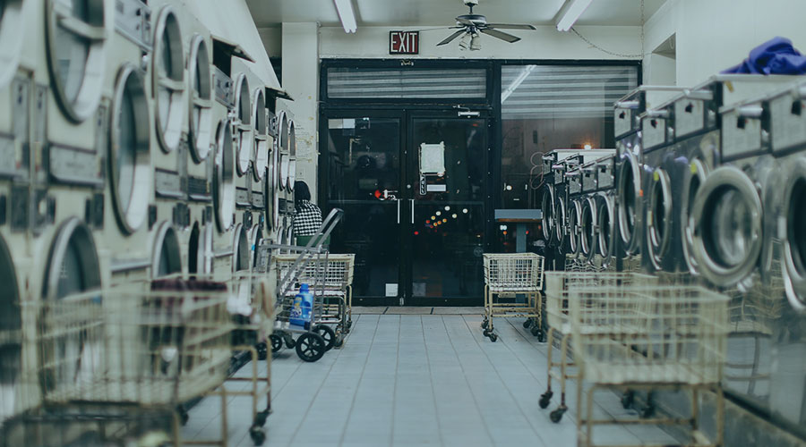 Image of an empty laundromat at night