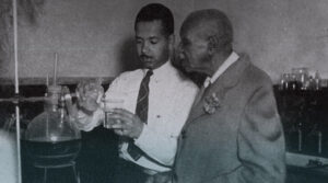 Two Black male scientists working on an experiment in a lab