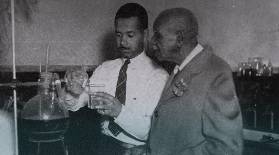 Two Black male scientists working on an experiment in a lab