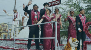 Image of Black American students in formal dress and standing on a float