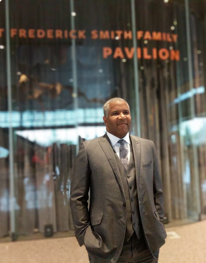 Robert F. Smith proudly stands in front of the Robert Frederick Smith Family Pavilion at the National Museum of African American History and Culture