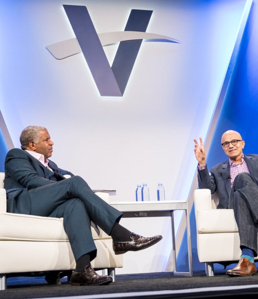 Robert F. Smith sits alongside interviewer with a Vista Equity Partners logo in the background