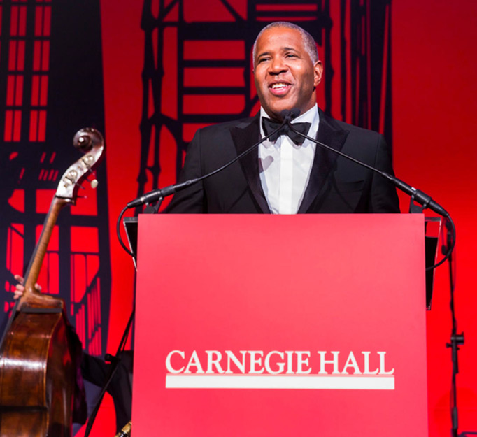 Robert F. Smith stands at a podium and delivers a speech at Carnegie Hall