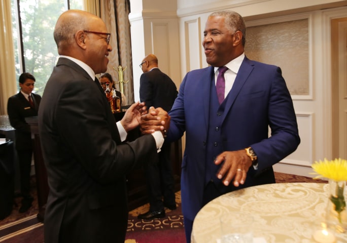 Robert F. Smith greets and shakes the hand of David A. Thomas, President of Morehouse College