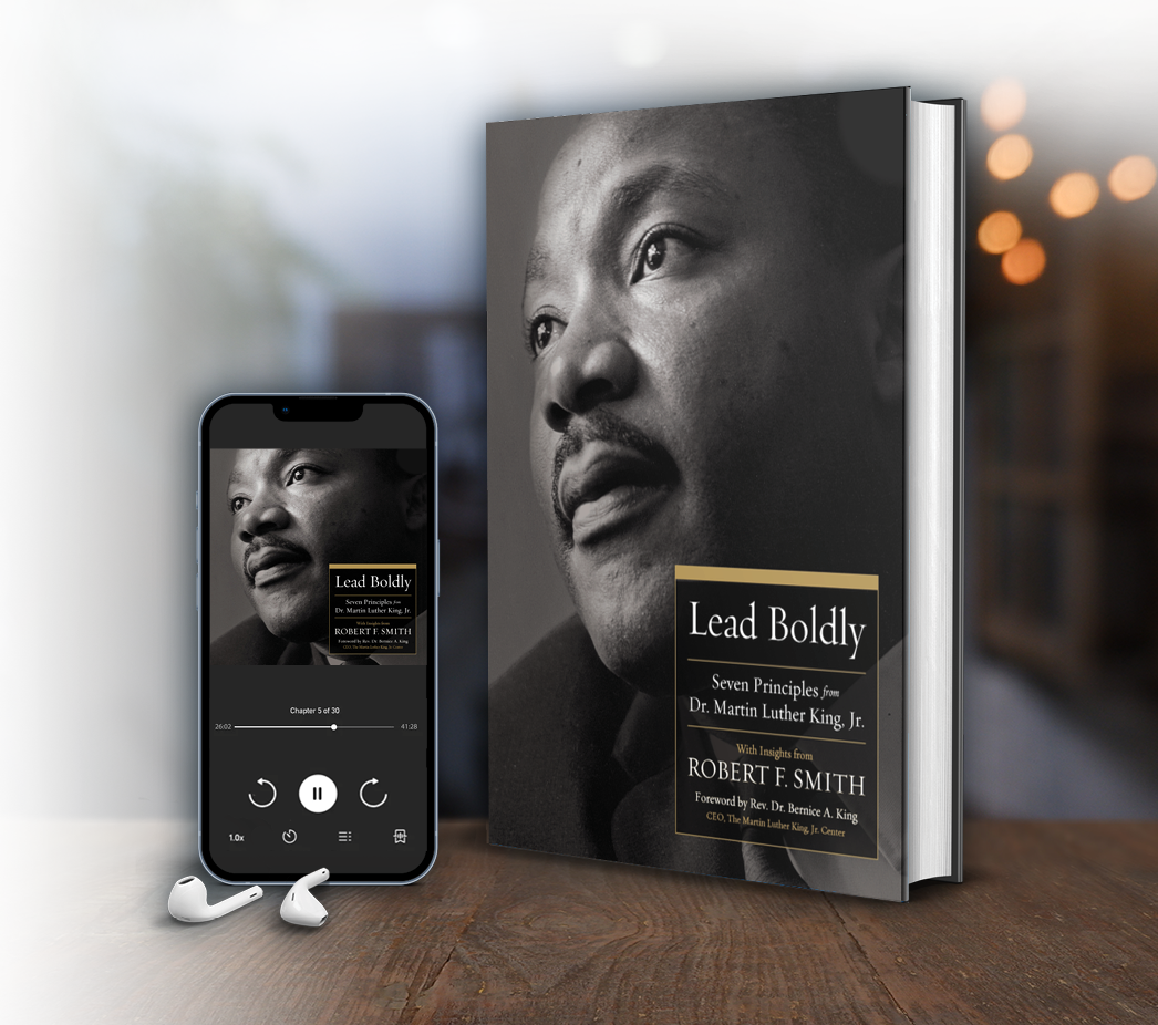 Hardcover edition of “Lead Boldly” placed next to an iPhone showcasing the audiobook version
