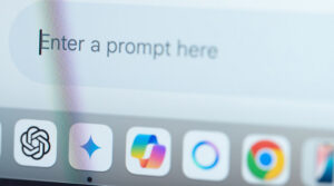 Website screen with a gray search box for a user to enter a prompt above program icons.